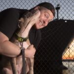 Pro pet photographer, J.B. Shepard, featured here with a rescue dog from Bella's Bully Buddies along the Baltimore Harbor waterfront in Canton.