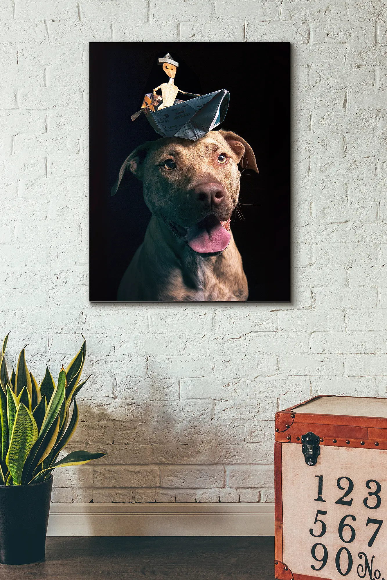 Portrait of a smiling brindle pitbull terrier rescue dog wearing a funny hat of a little man in a tiny cardboard row boat. Captured at Puptrait, a dog-friendly photography studio in Baltimore, Maryland. Professional Pet Photographer near Washington D.C.